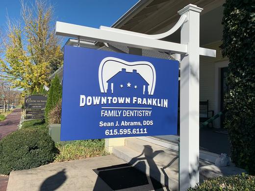 Post-and-panel business sign for a family dentistry practice